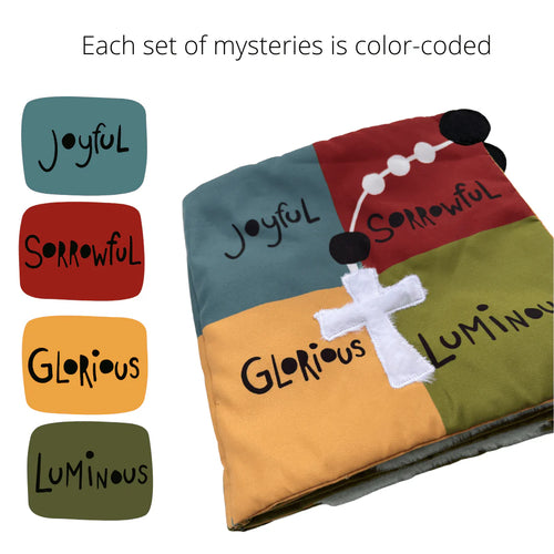 Color-coded fabric square panels labeled joyful, sorrowful, glorious, and luminous with white rosary and cross on quiet book cover