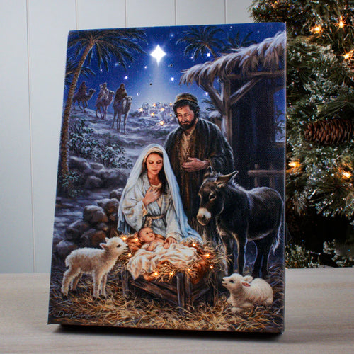 A Savior is Born" 8x6 lighted tabletop canvas featuring nativity scene with Mary, Joseph, baby Jesus, animals, and shining star