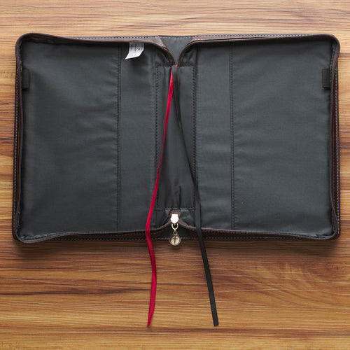 Inside view of blush floral faux leather Bible cover with black interior, red and black ribbon bookmarks, and zipper pocket