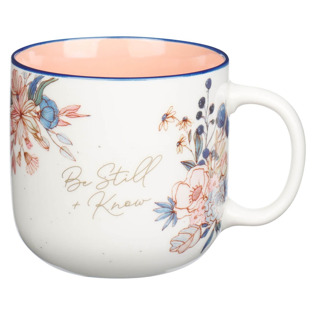 Ceramic coffee mug with peach interior and floral design featuring “Be Still & Know” scripture text