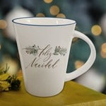 White ceramic Christmas mug with "Feliz Navidad" gold script and holly decorations, ideal for holiday warmth and comfort.