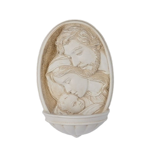 Ivory-toned Holy Family holy water font with carved relief of Mary, Joseph, and baby Jesus in oval frame