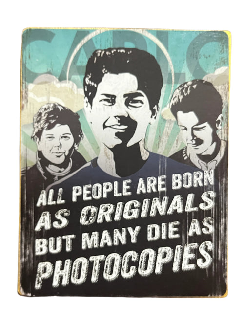 4.5" wooden block with black and white portraits of Carlo Acutis and quote on originality against blue background
