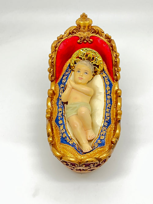 3 7/8" Advent Infant Jesus figurine with gold halo lying in ornate painted manger, hand-crafted resin design