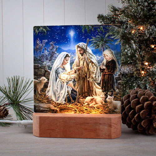LED tabletop nativity scene ornament plaque with Mary, Joseph, baby Jesus, lambs, and Star of Bethlehem at night