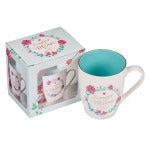 White ceramic mug with teal interior, "La Mejor Mamá" floral design, and matching decorative gift box