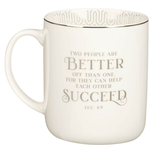 White ceramic coffee mug with Ecclesiastes 4:9 scripture quote in beige lettering and decorative rim design