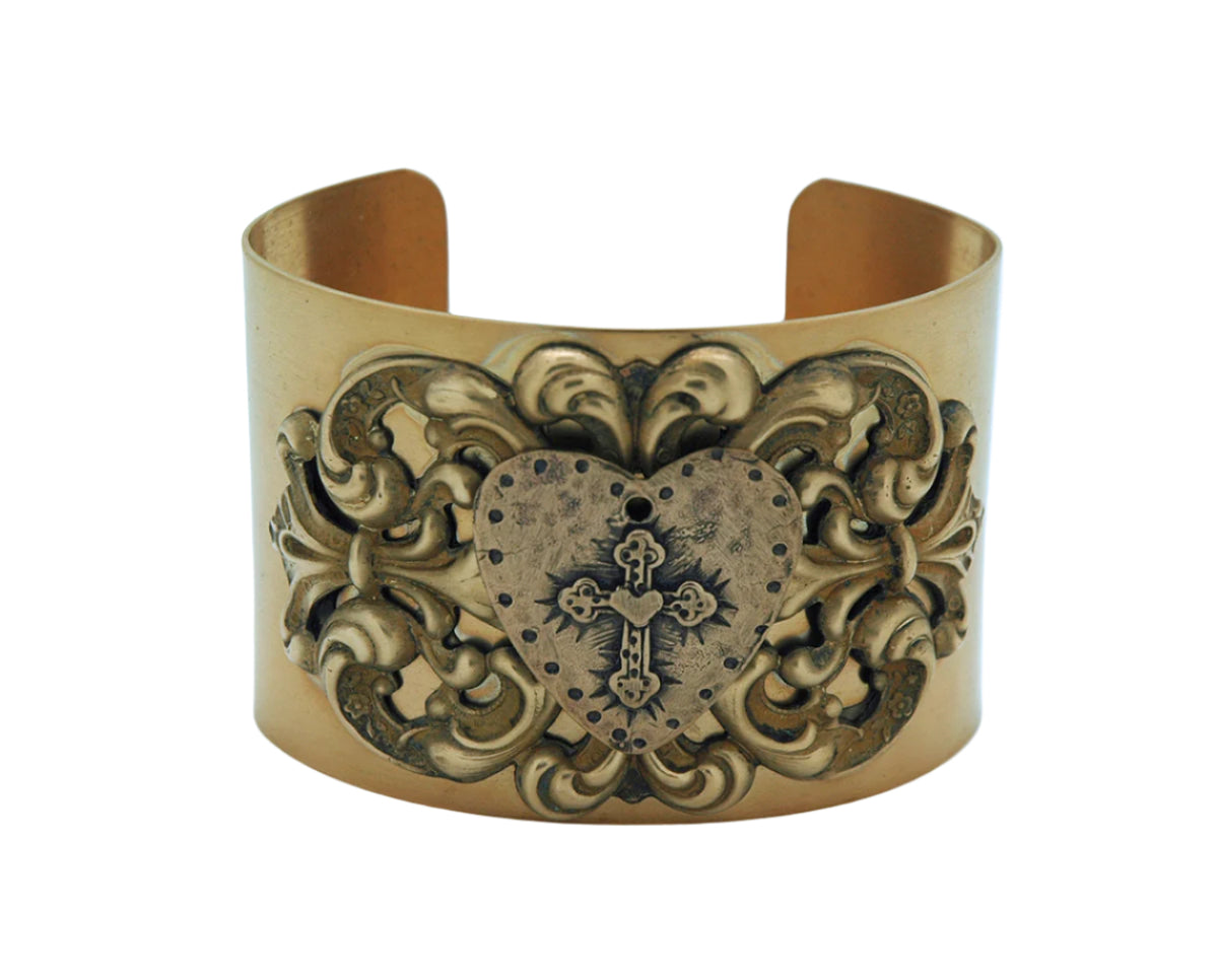 Vintage style cuff bracelet with hammered heart and detailed cross medal on ornate antique finish band