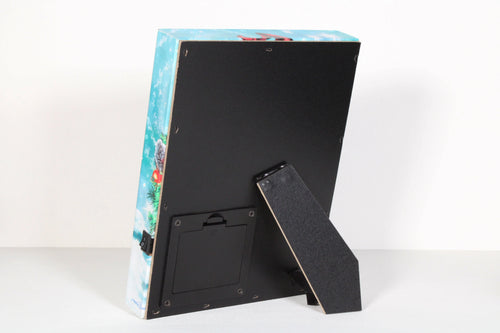 Back view of A Savior is Born 8x6 lighted tabletop canvas with stand and battery compartment visible.